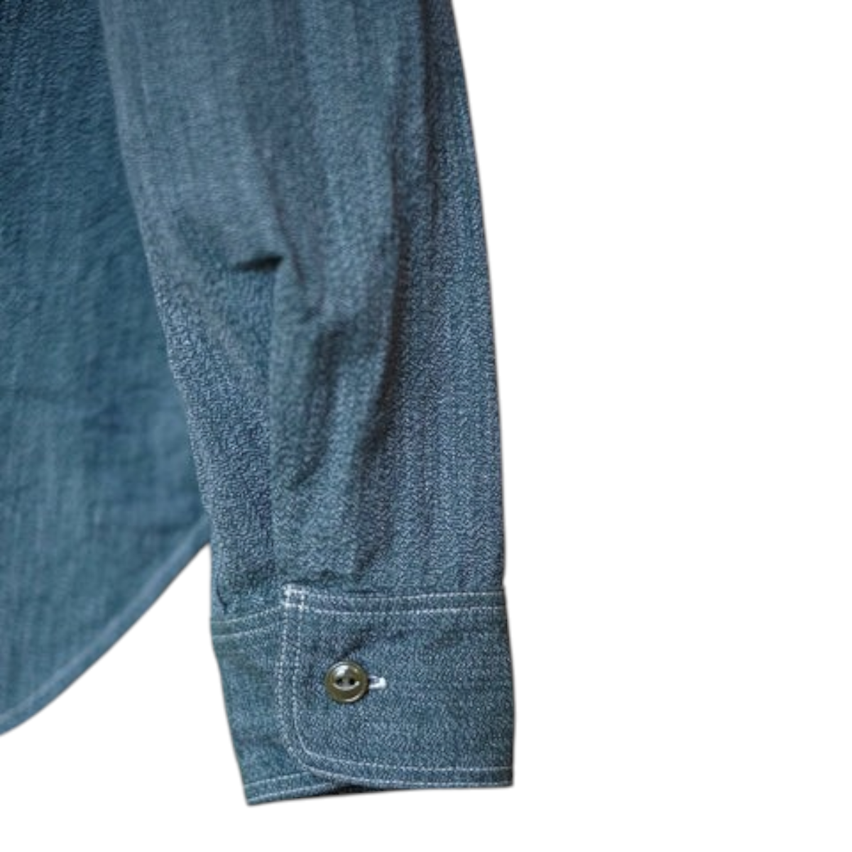 MILWORKS Atlas work shirt sleeve in sage green 6.5 oz. selvedge salt and pepper chambray with cat's eye button cuff.