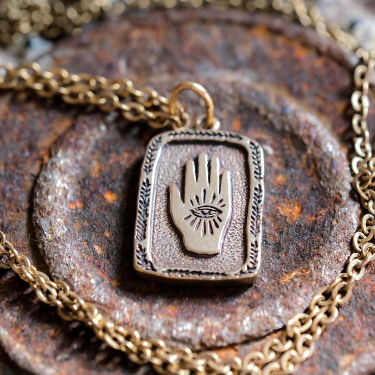 Eye in Hand Necklace Brass