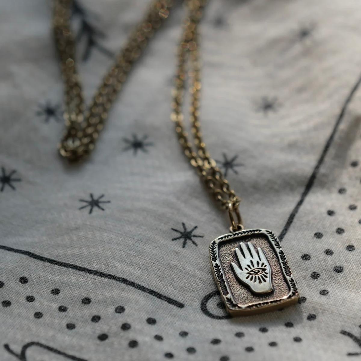 Eye in Hand Necklace Brass
