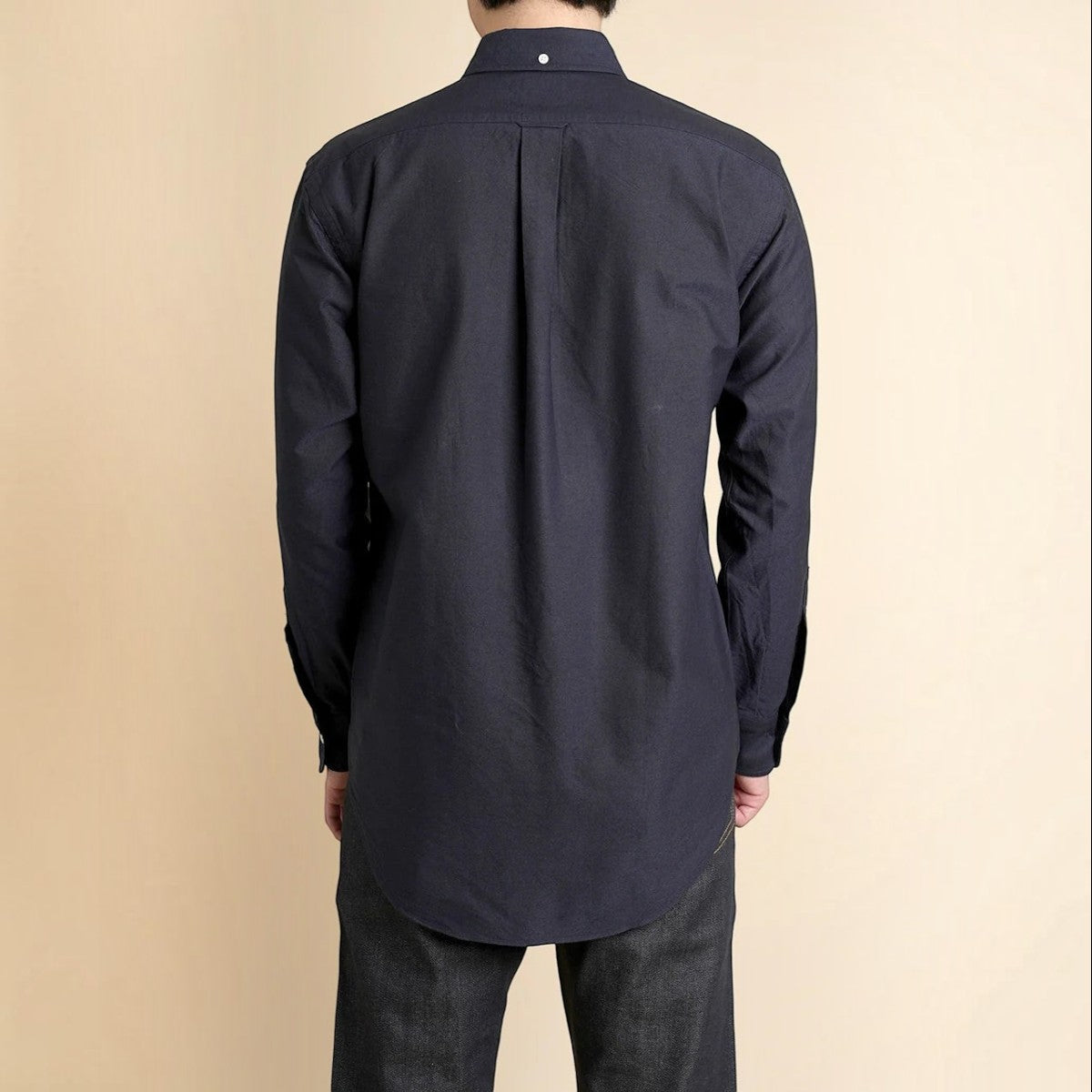 Back view of a Kamakura navy cotton oxford button-down shirt featuring a box pleat, locker loop, and collar button.