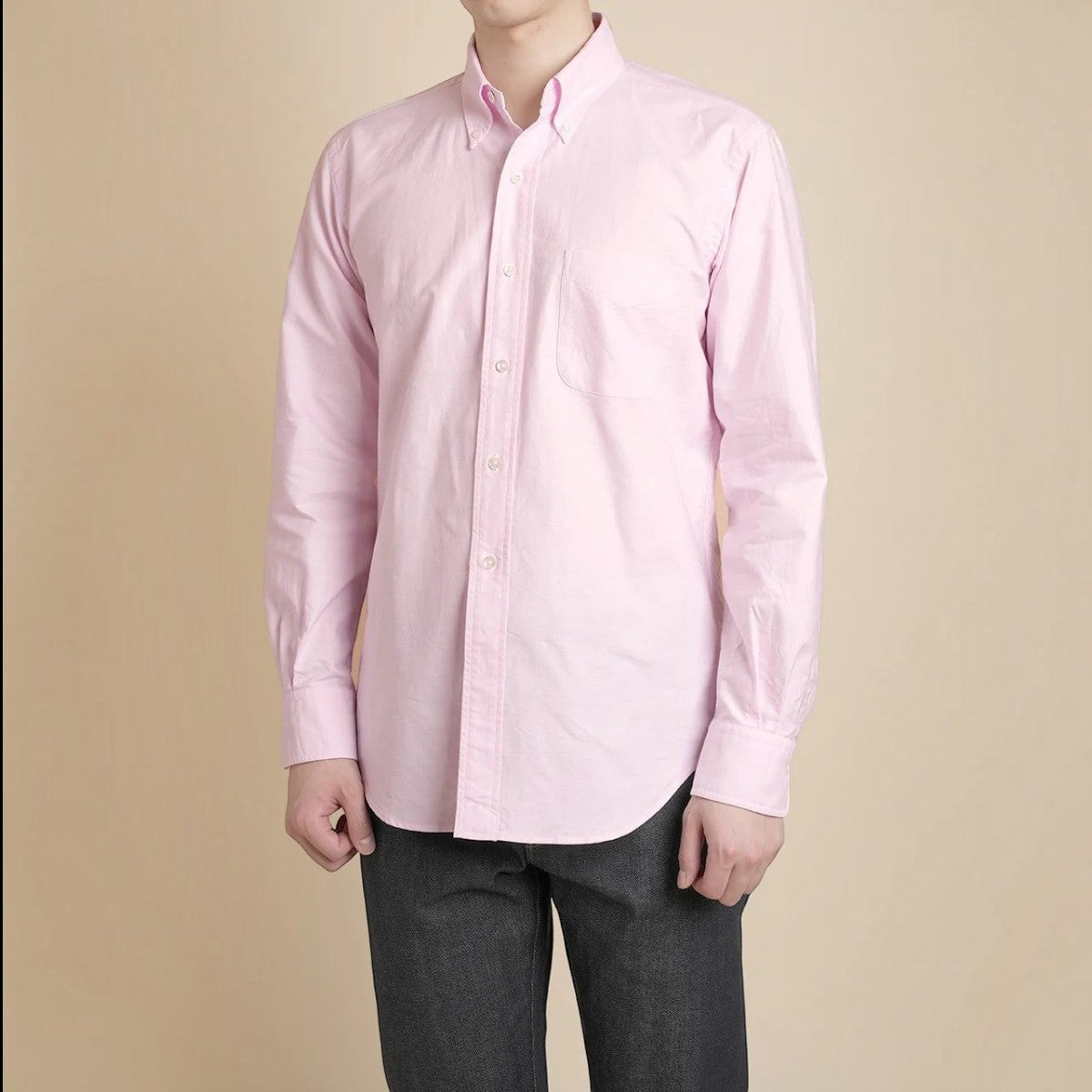 Kamakura pink cotton oxford button-down shirt with chest pocket, long sleeves, and shell buttons on a male model.