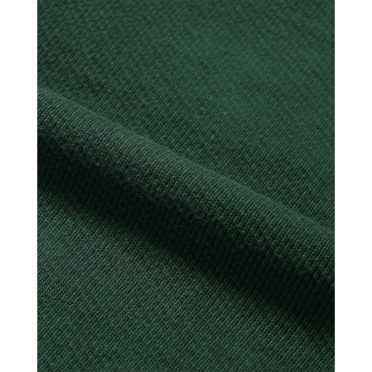 Close-up of MILWORKS racing green double heavyweight French terry cotton fabric with a soft, brushed texture.