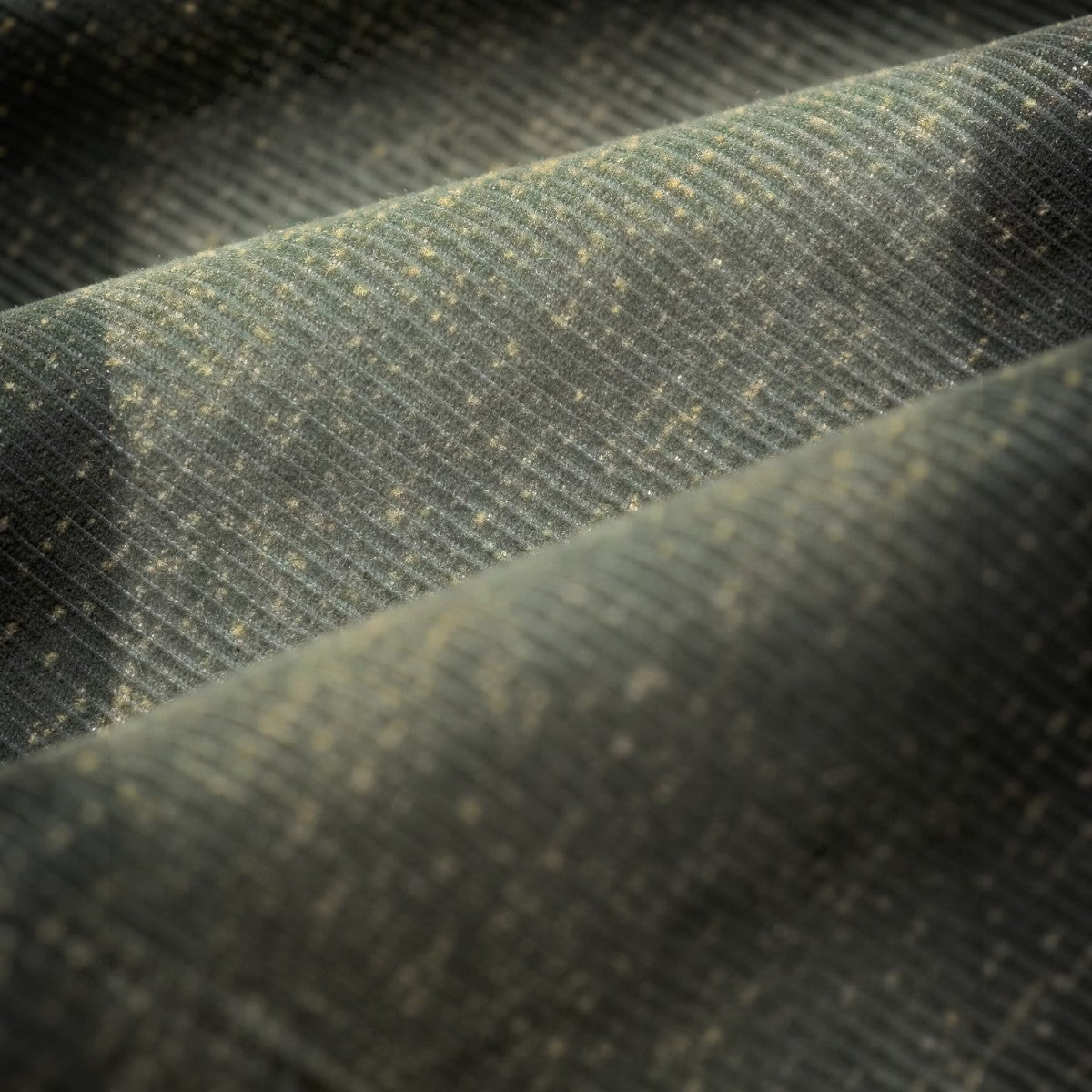 Close-up of RRL vintage grey cotton corduroy fabric with a speckled discharge-printed jaspé texture.
