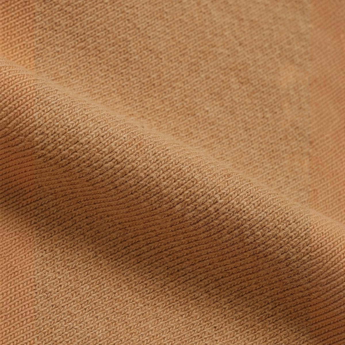 Close-up of MILWORKS Foxfibre Coyote 80 heavyweight French terry cotton fabric with a rich brown textured knit.