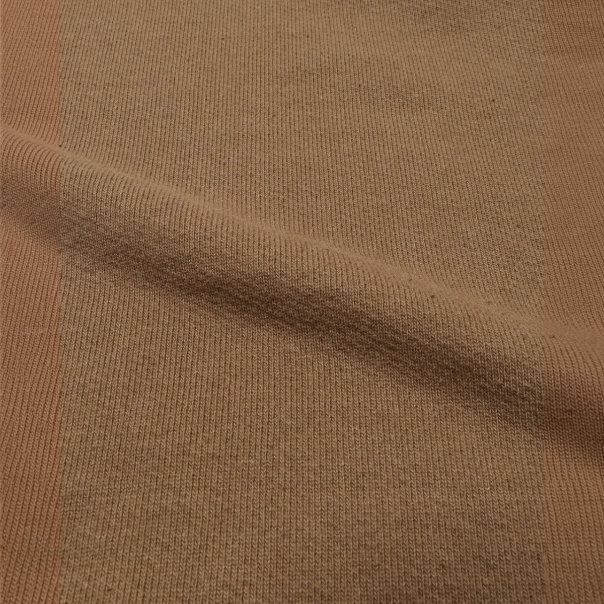 Close-up of MILWORKS coyote 80 Foxfibre cotton French terry fabric with a rich earthy brown texture.