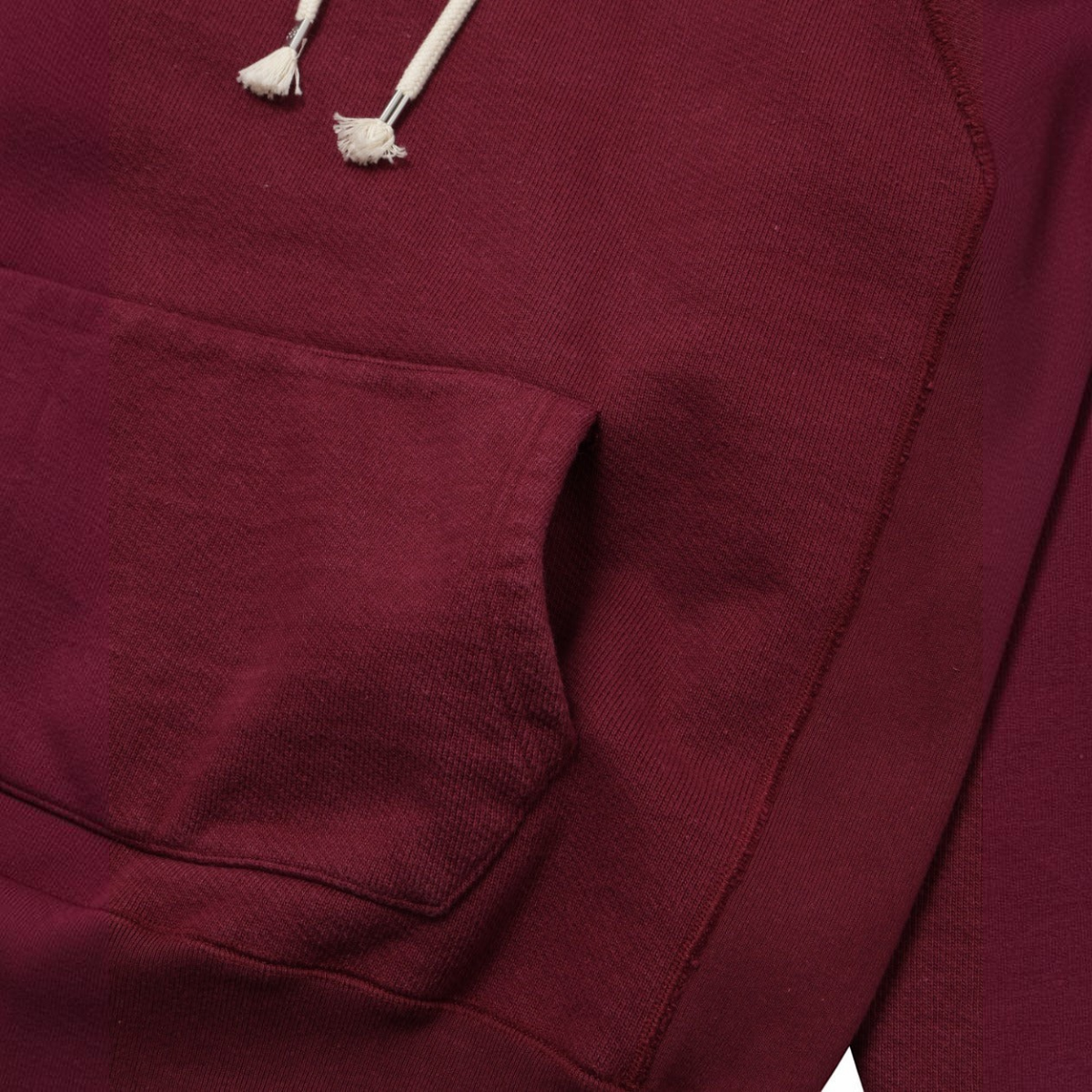 MILWORKS burgundy double heavyweight French terry pullover hoodie with drawstring hood and front kangaroo pocket.