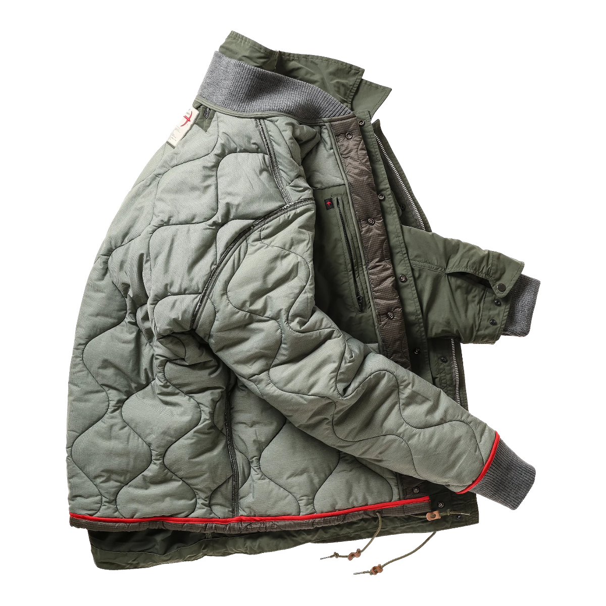 Milworks Relwen Defender 2-in-1 jacket in dark forest green with a quilted insulated liner and rib-knit cuffs.