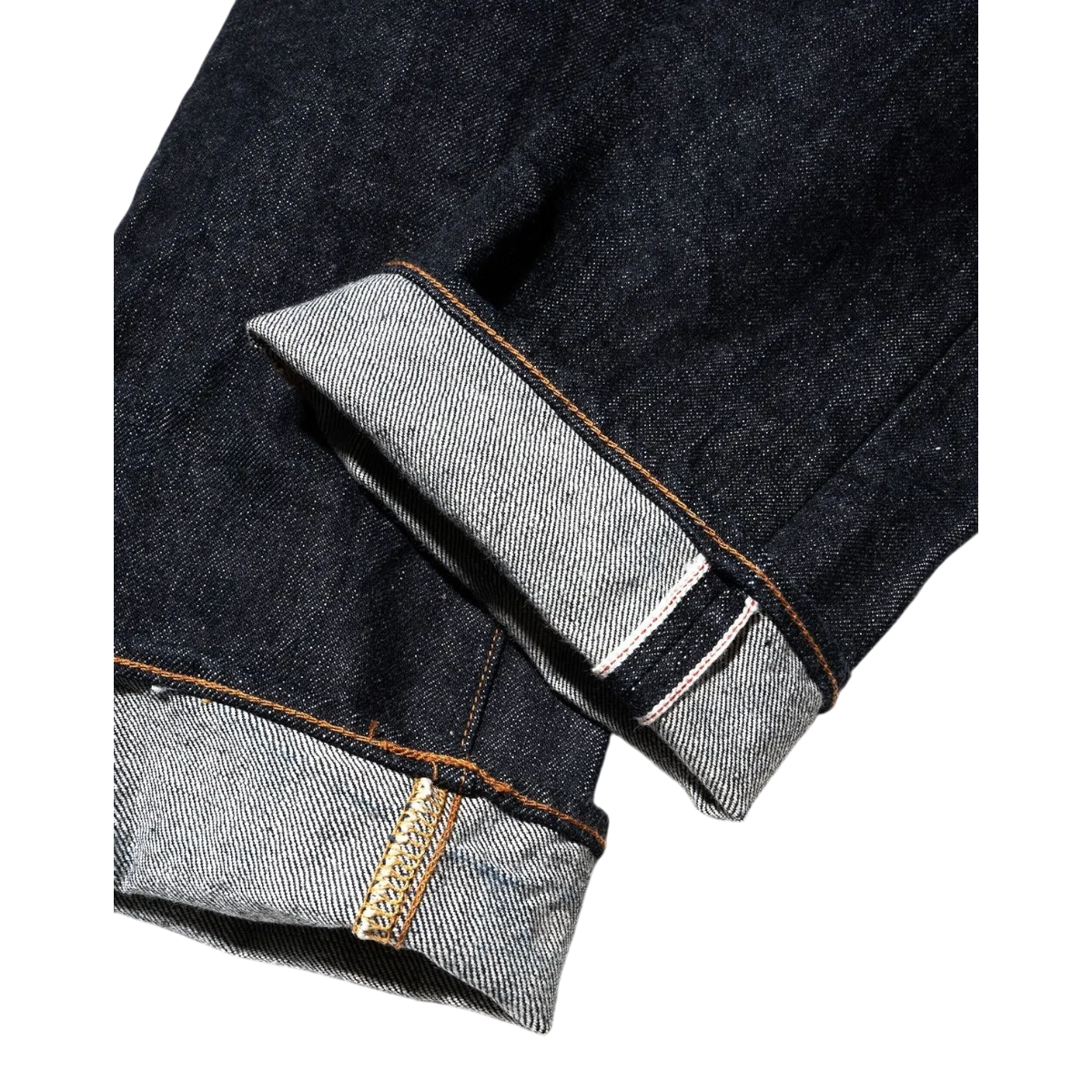 MILWORK dark indigo 17oz heavyweight selvedge denim jeans, slim fit, one wash. Close-up of cuffed leg showing selvedge detail.