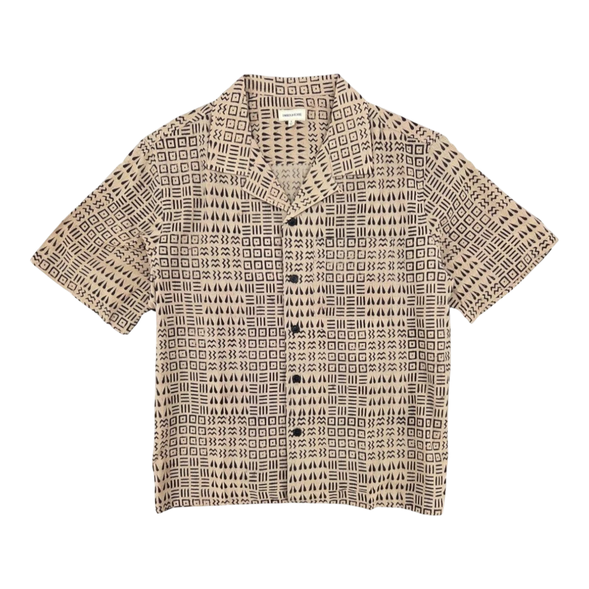 MILWORK Khushi Camp Shirt in black tile block print on a beige 100% cotton fabric. Features a relaxed fit, spread collar, short sleeves, and a chest pocket.