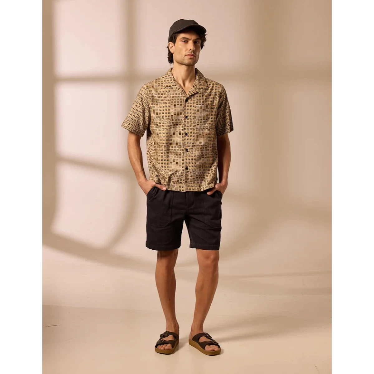 MILWORK Khushi Camp Shirt in black with tile block print, short sleeves, spread collar, and chest pocket. 100% cotton.