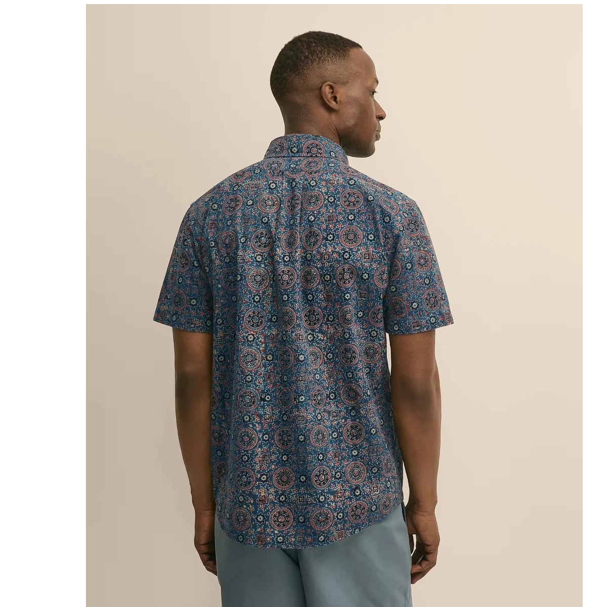 MILWORK blue cotton short sleeve shirt with a repeating circular block print in spice and navy. Classic fit.