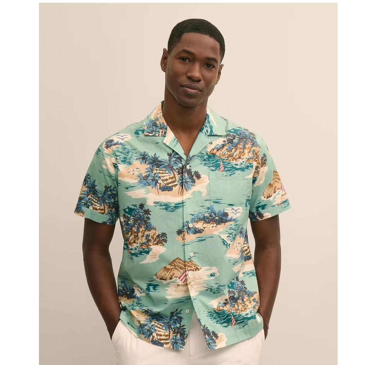 MILWORK blue 100% cotton camp collar shirt with an island motif pattern, short sleeves, and a regular fit.