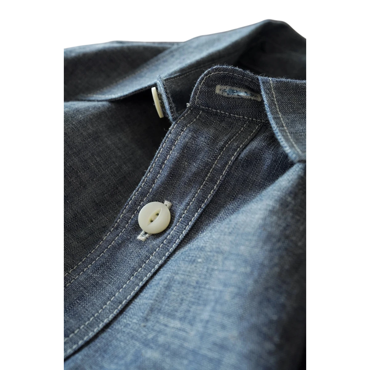 MILWORK blue selvedge chambray work shirt with natural shell button and triple-needle stitching.