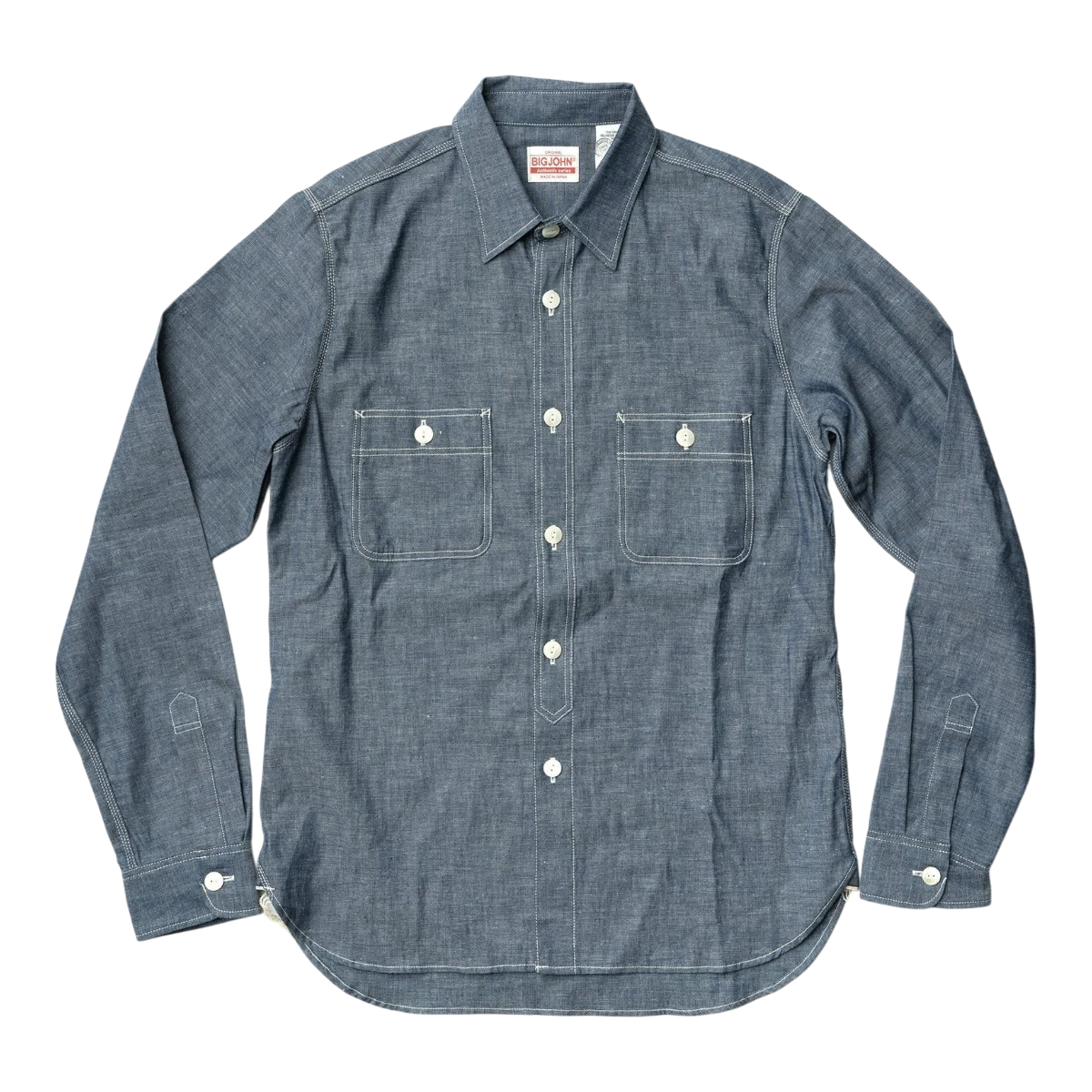 MILWORK blue selvedge chambray work shirt with white contrast stitching, two chest pockets, and shell buttons.