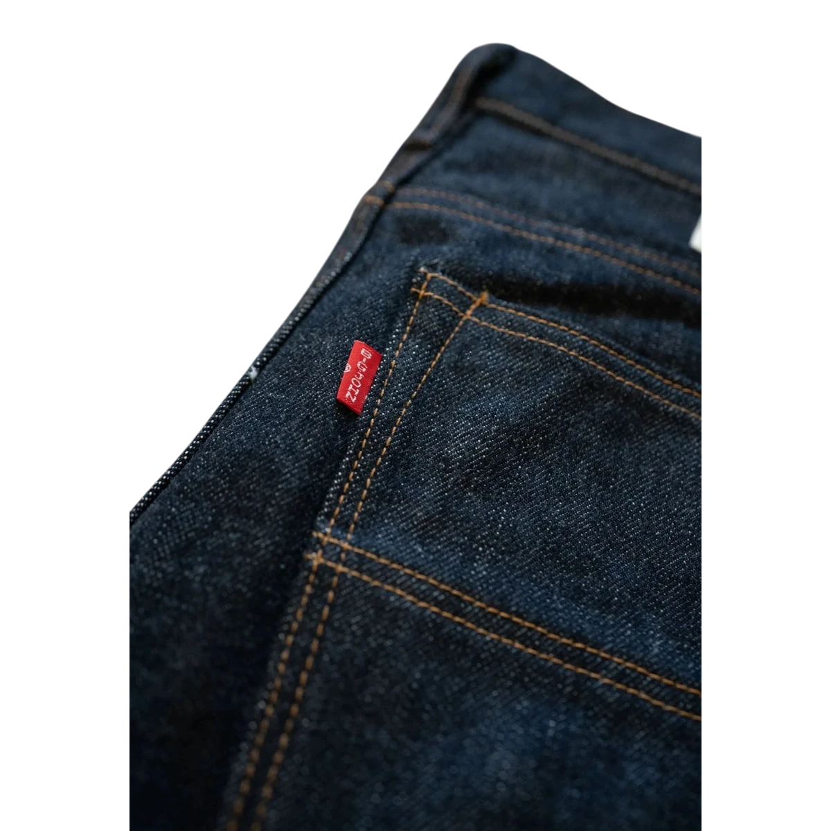 MILWORK dark indigo 17oz selvedge denim slim fit jeans with red tab detail and orange stitching.