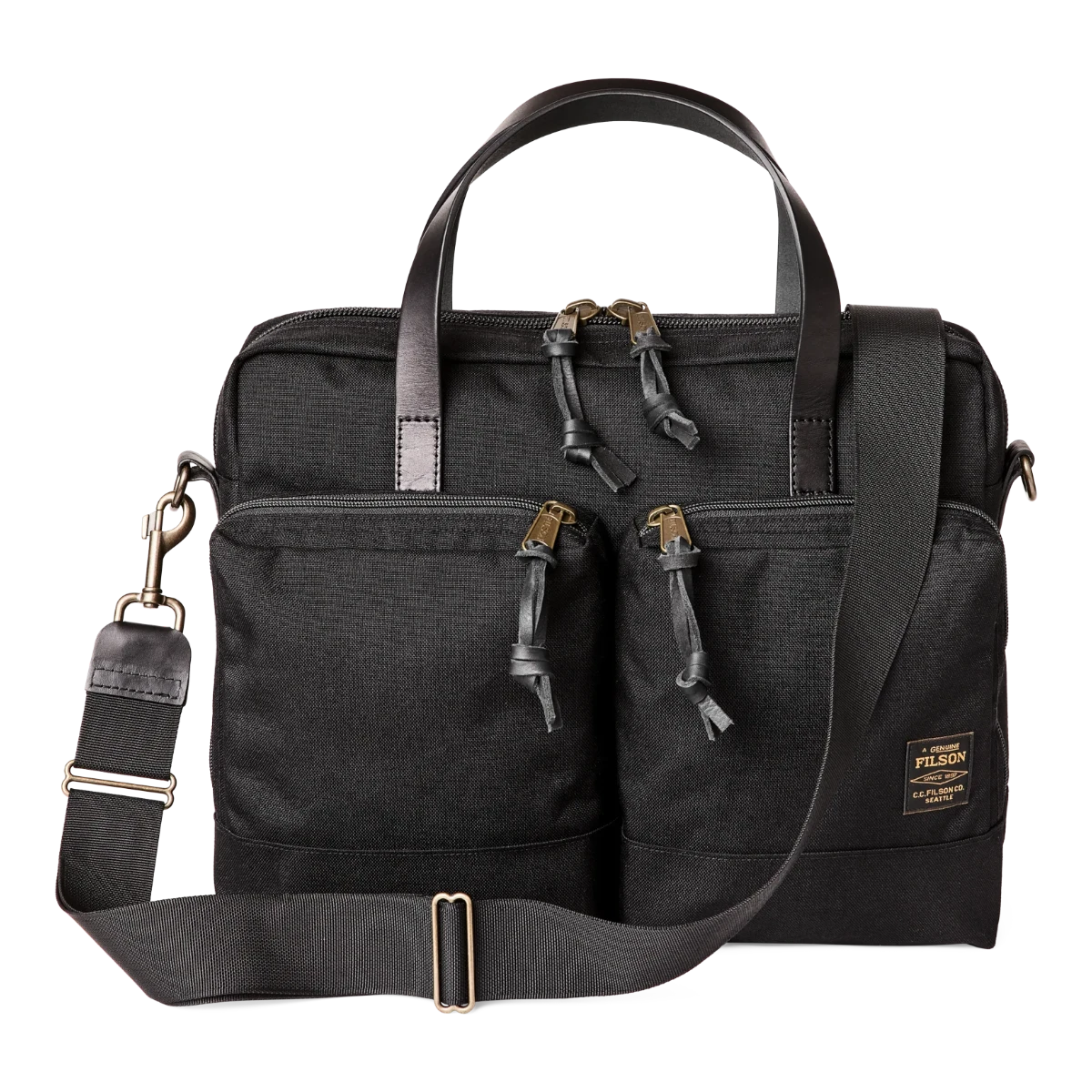 MILWORK Dryden Briefcase in black abrasion-resistant Cordura nylon with leather handles and brass zippers. Features exterior pockets and a laptop sleeve.