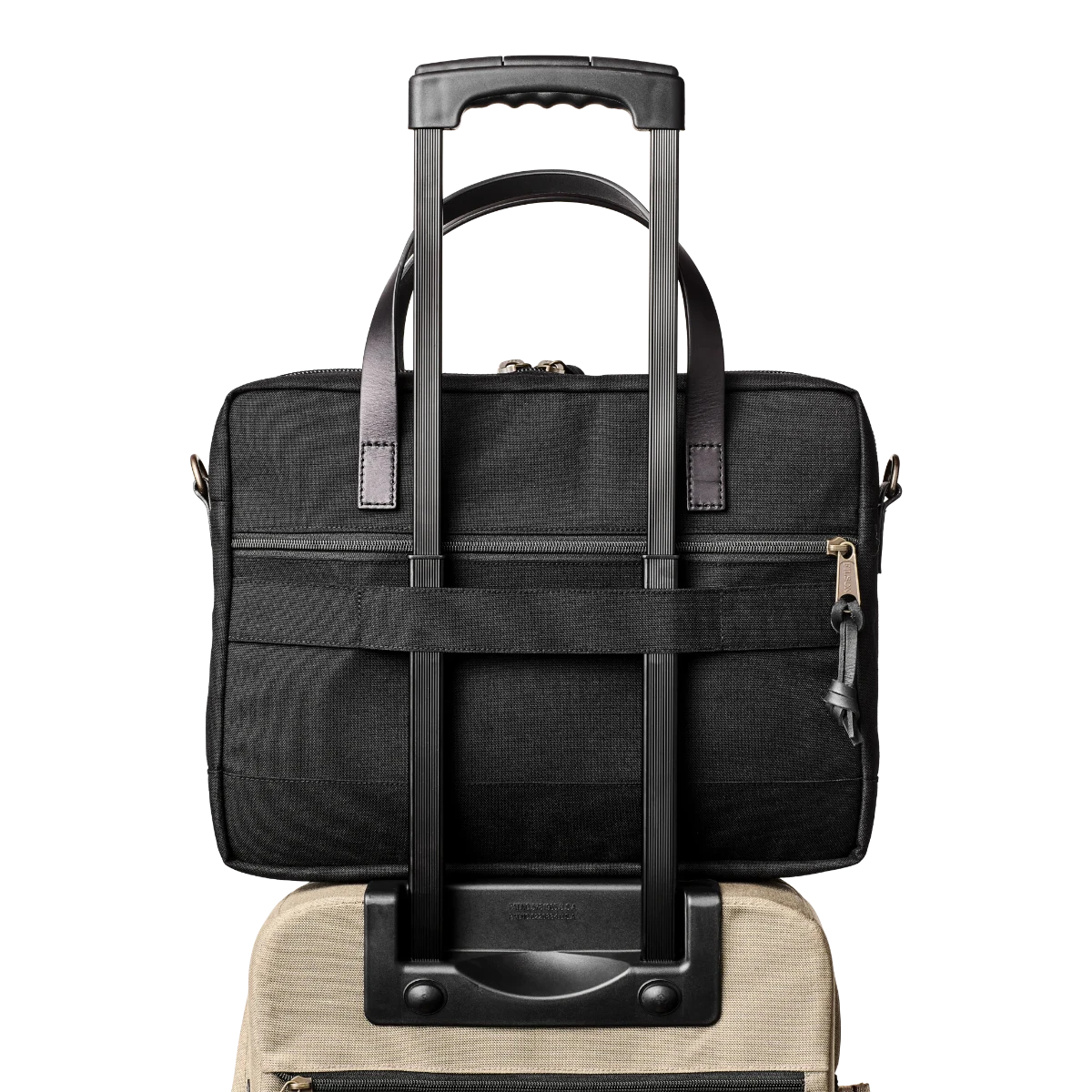 MILWORK Dryden Briefcase in black abrasion-resistant Cordura nylon with padded laptop sleeve and trolley strap.