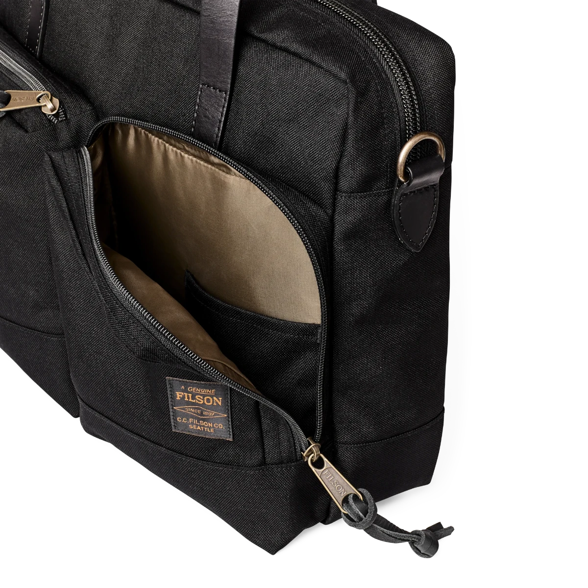 MILWORK Dryden Briefcase in black abrasion-resistant Cordura nylon with leather accents and brass zippers. Features exterior pockets and a padded laptop sleeve.