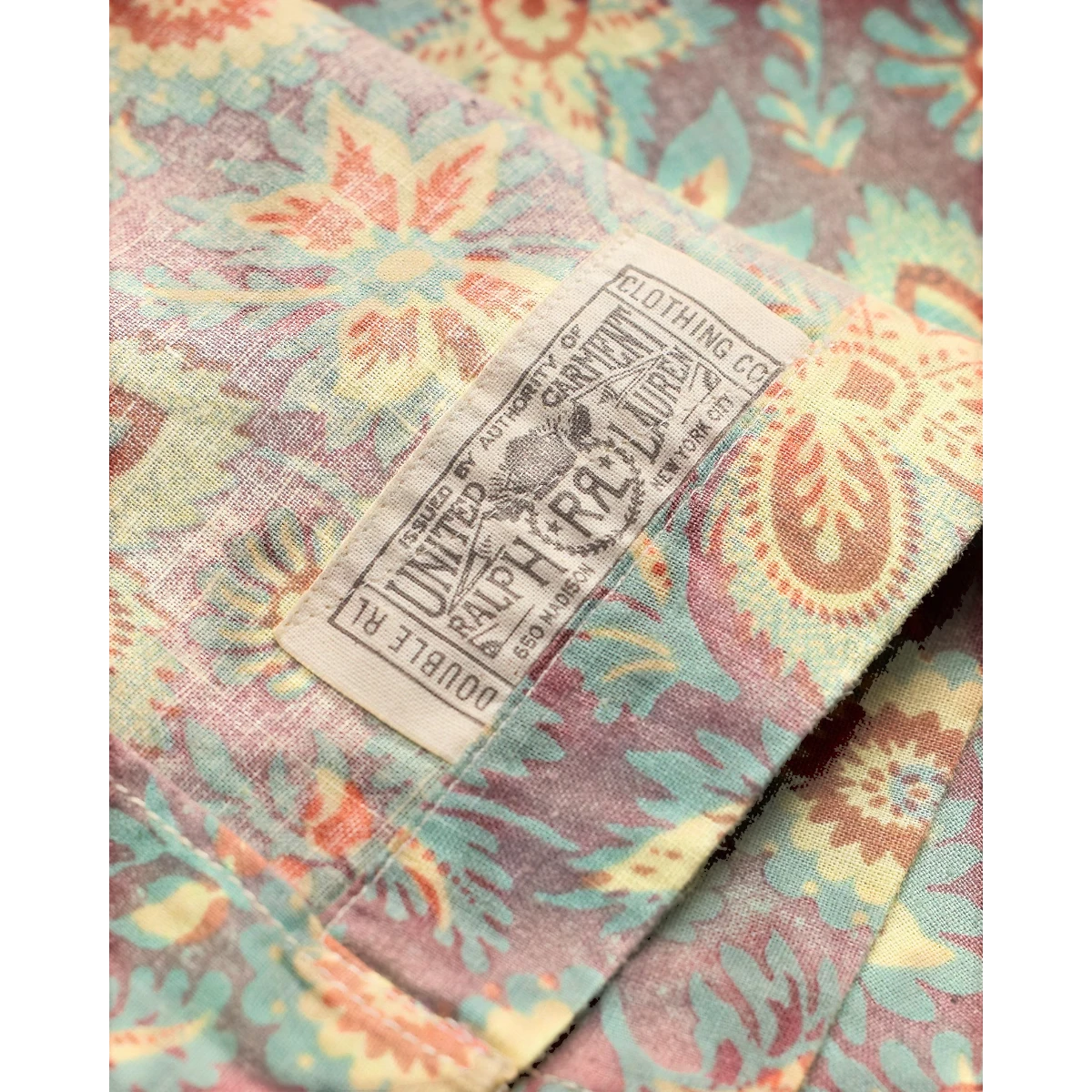 MILWORK floral print camp shirt in blue, red, and multi-color linen-cotton blend. Features a vintage-inspired pattern and coconut shell buttons.