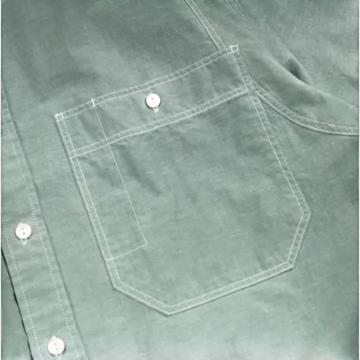 MILWORK green cotton chambray work shirt with dual chest pockets and white contrast stitching. Relaxed fit.