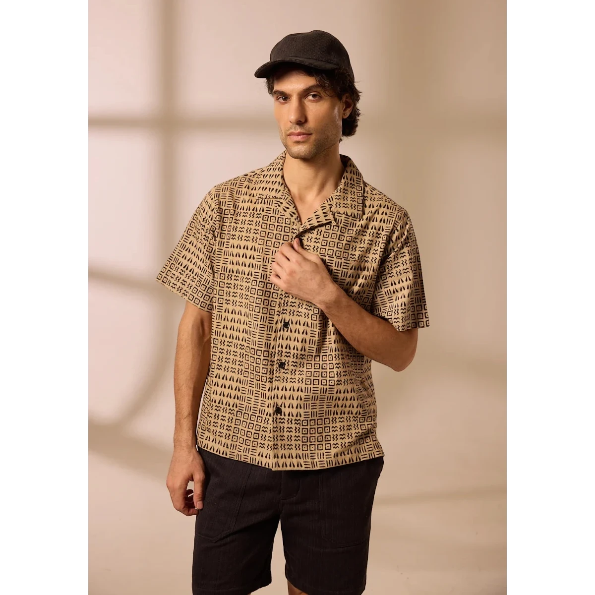 MILWORK Khushi Camp Shirt in black tile block print on a tan cotton base. Relaxed fit, short sleeves, spread collar, chest pocket.