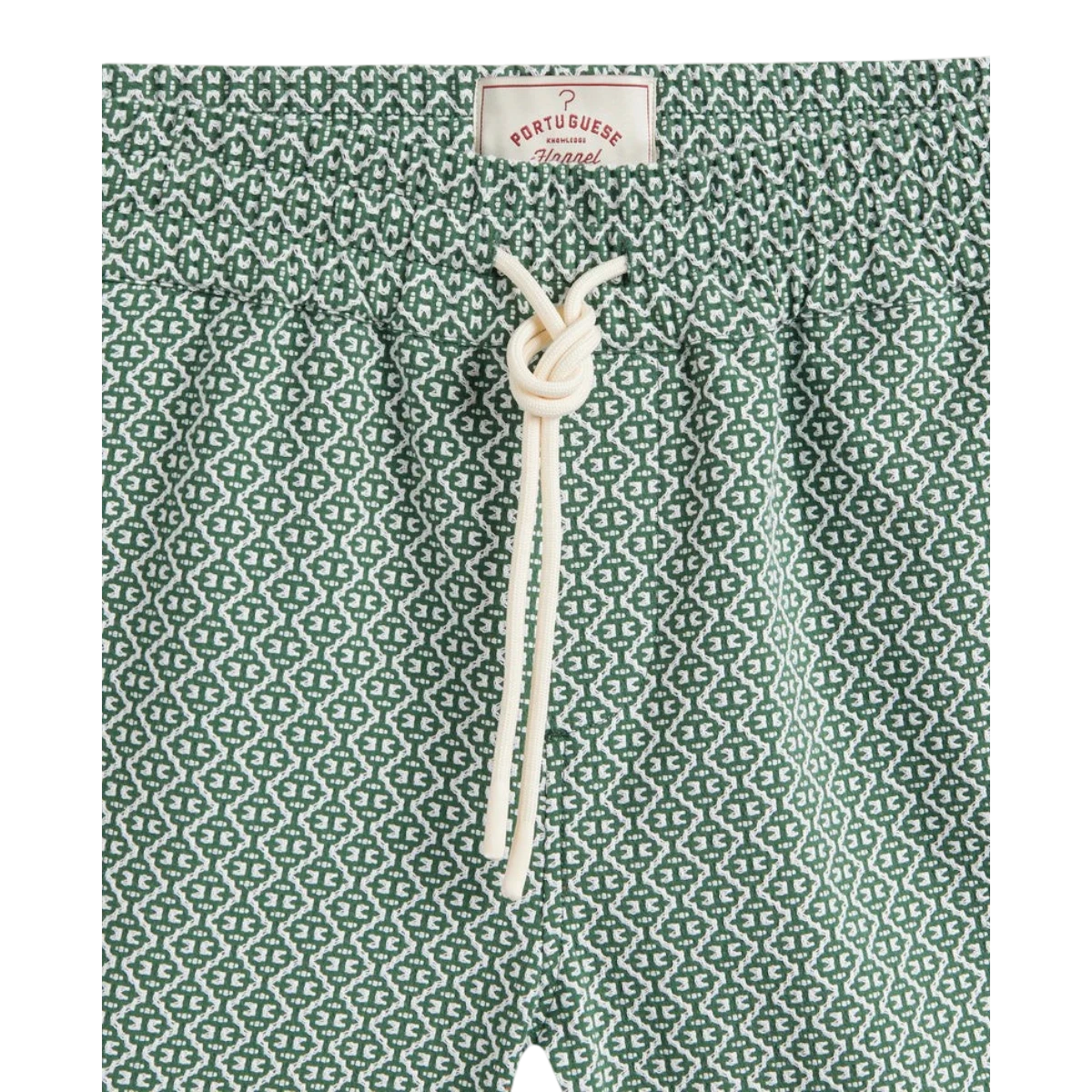 MILWORK Portuguese Tile Shorts in green with white geometric pattern, 99% cotton, 1% elastane, drawstring waist.