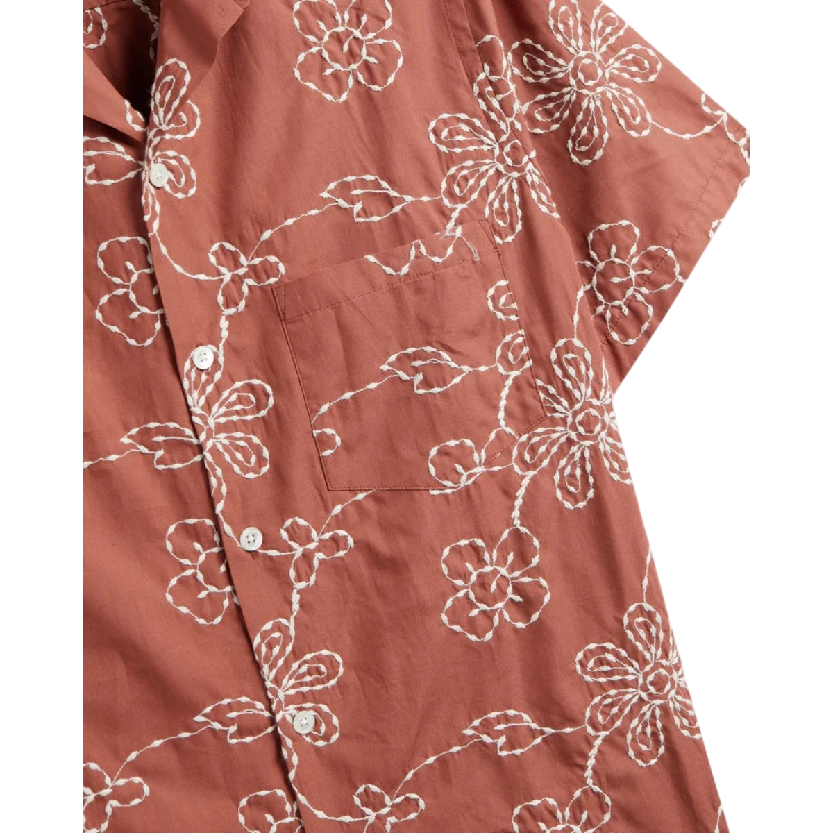 MILWORK Compota Shirt in rust orange cotton blend with white floral embroidery, short sleeves, and mother of pearl buttons.
