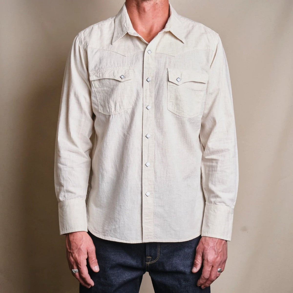 MILWORK Sand Calico Western style shirt with sawtooth flap pockets, diamond snaps, and cotton-linen blend.