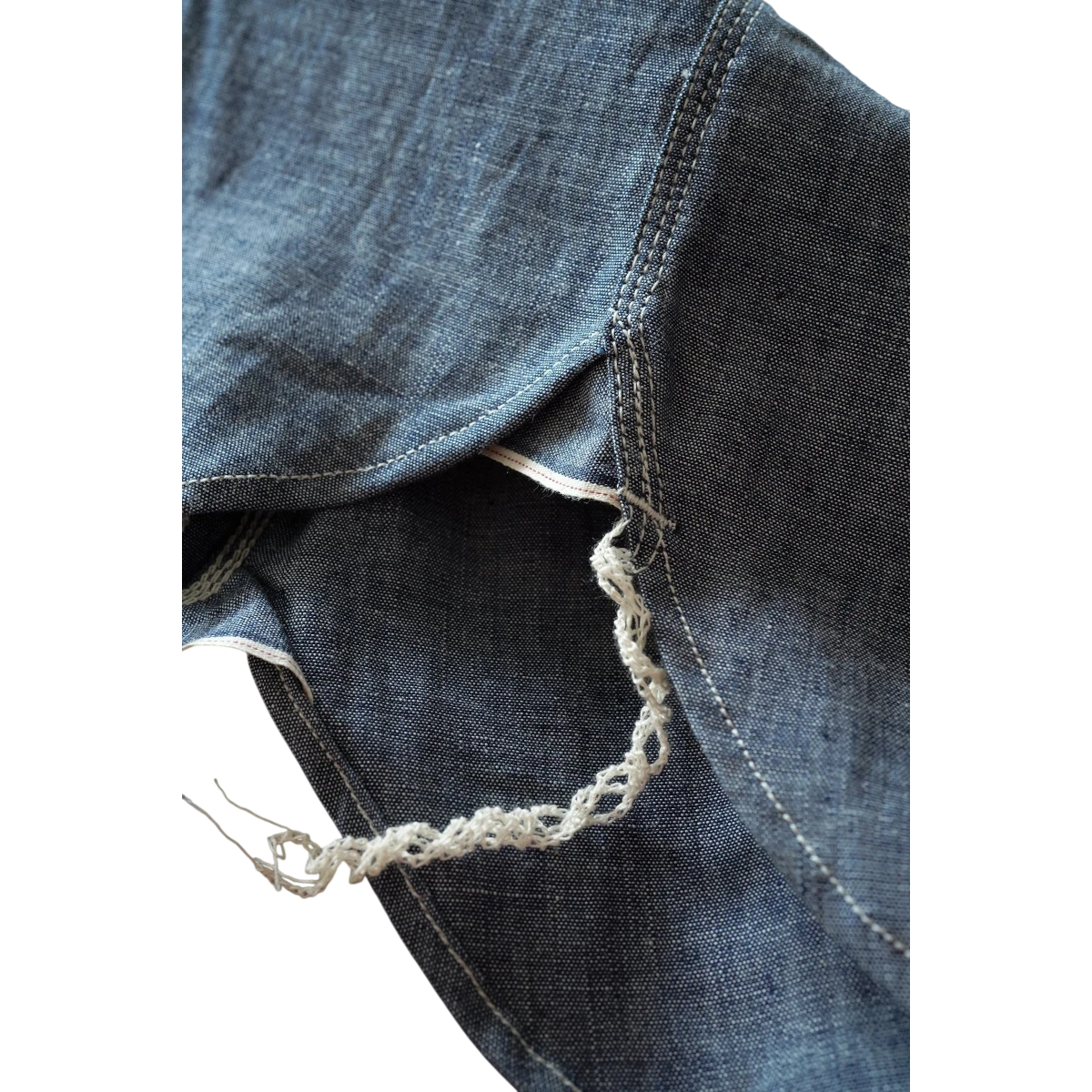 MILWORK Selvedge Chambray Work Shirt in indigo blue, featuring triple-needle stitching and a raw selvedge detail.