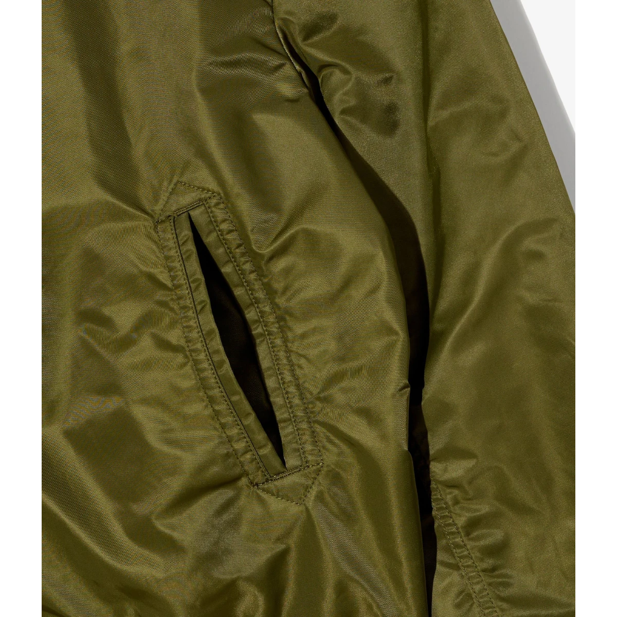 MILWORK USNA olive green satin nylon flight jacket with a welt pocket detail.