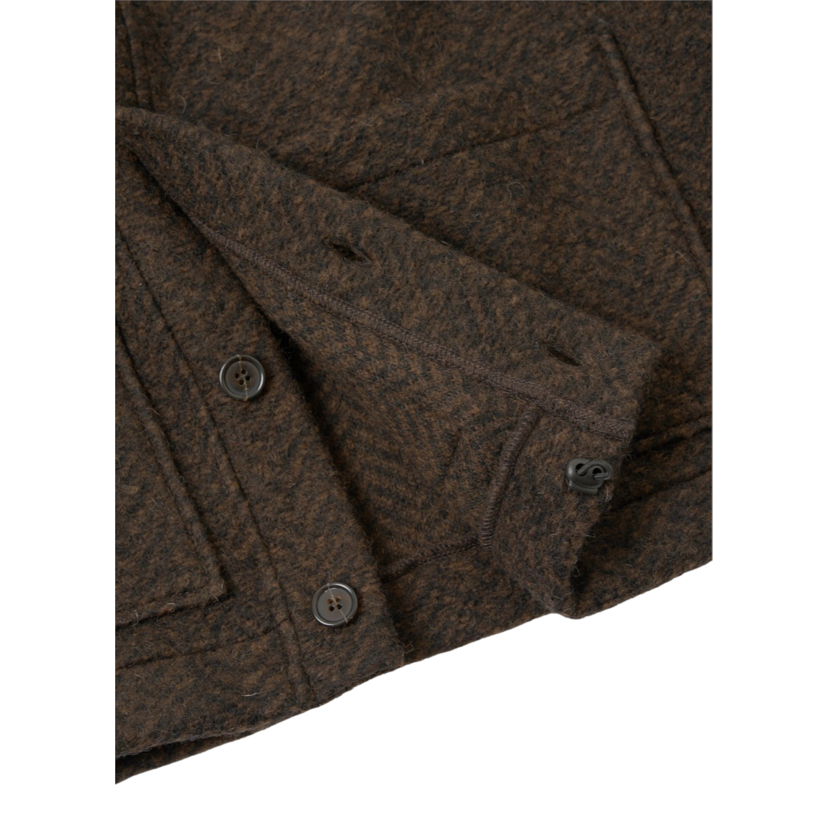 Close-up of the MILWORKS Advance Cardigan in brown fleece, showing the textured fabric, button placket, and pocket.