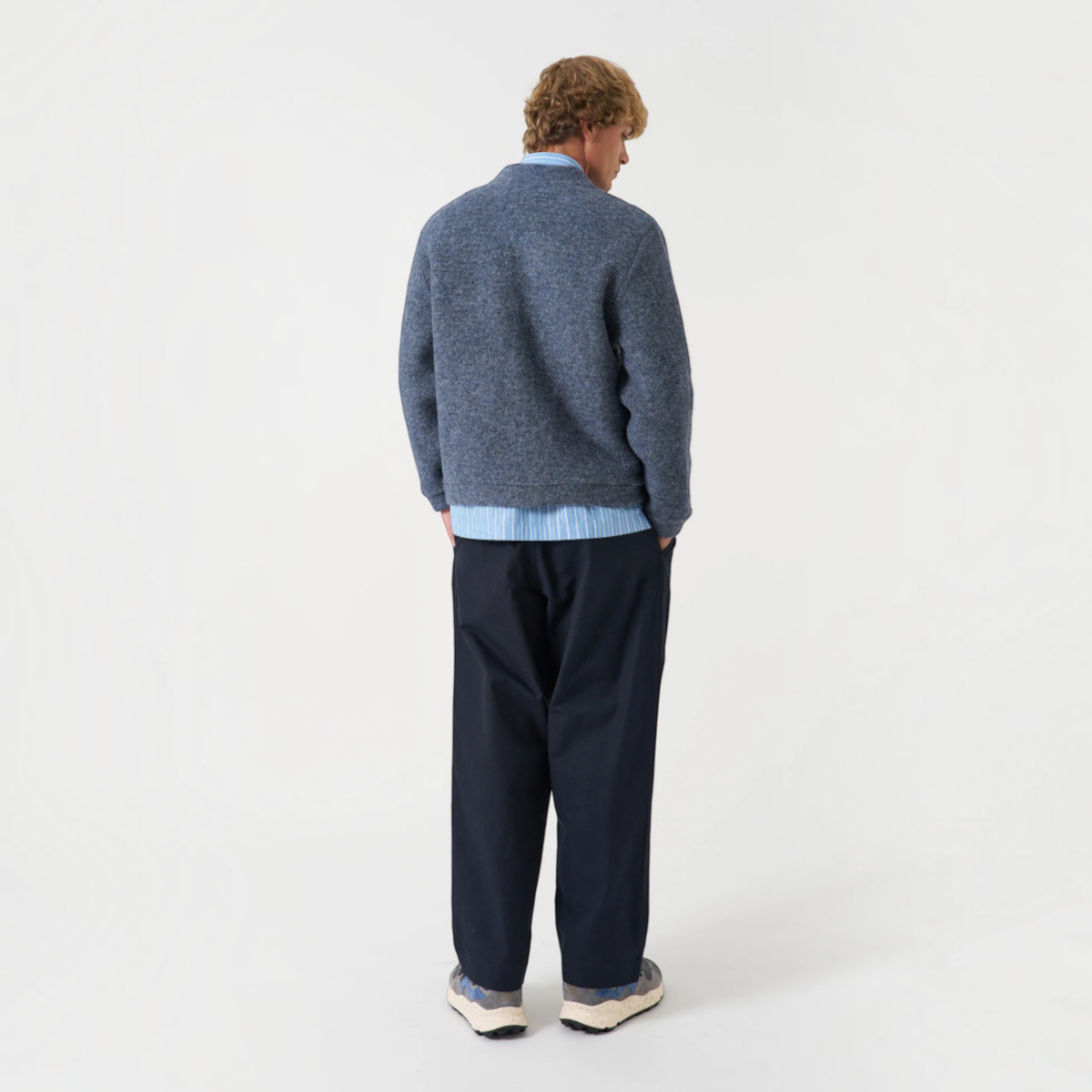 MILWORKS Advance cardigan in slate blue wool fleece with a boxy fit, worn by a man from the back view.