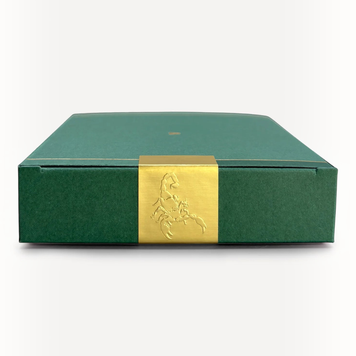 MILWORKS American Ash perfume box in dark green with a gold scorpion emblem band on a white background