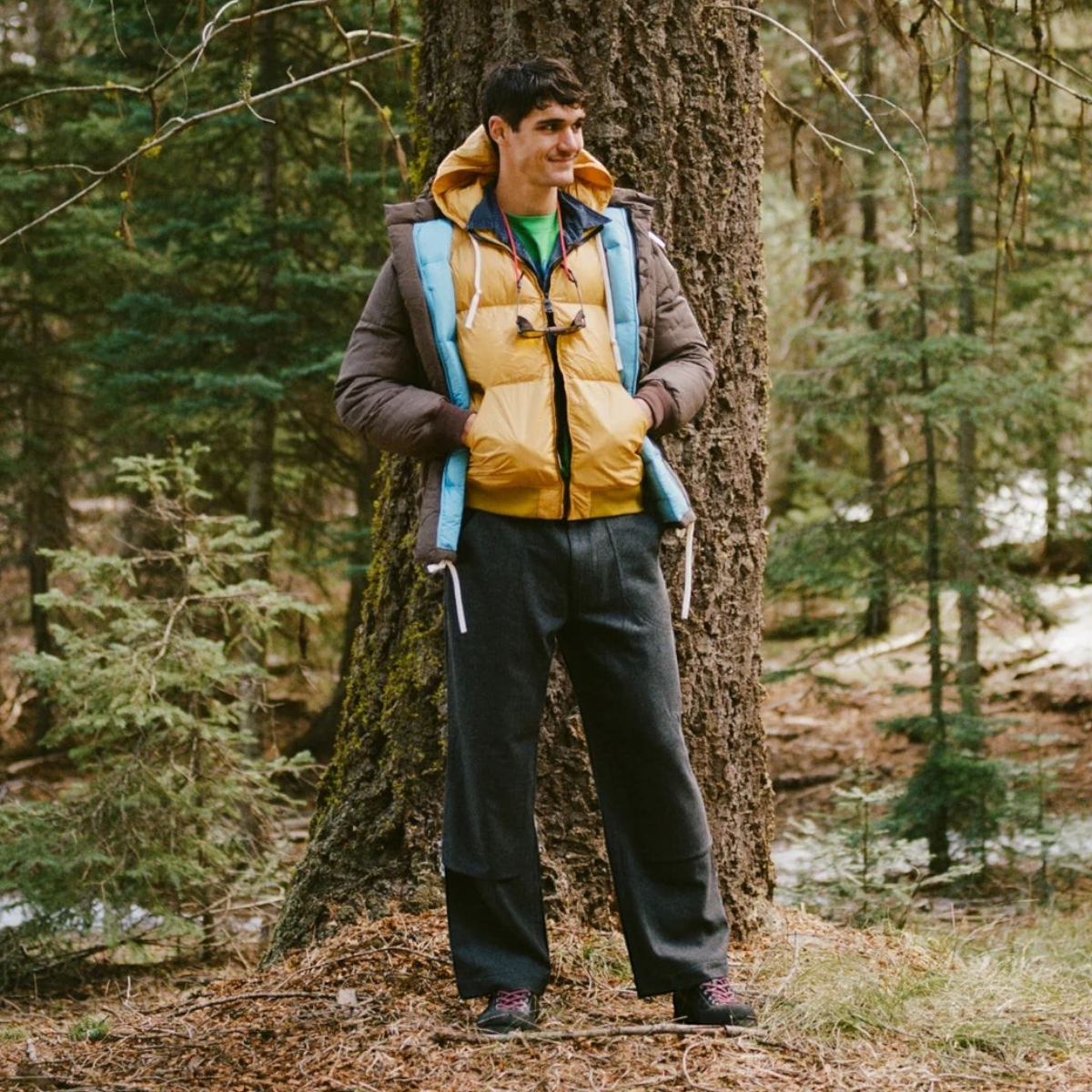 MILWORKS Arctic Parka in cappuccino brown with a yellow and blue interior, worn by a man in a forest setting.