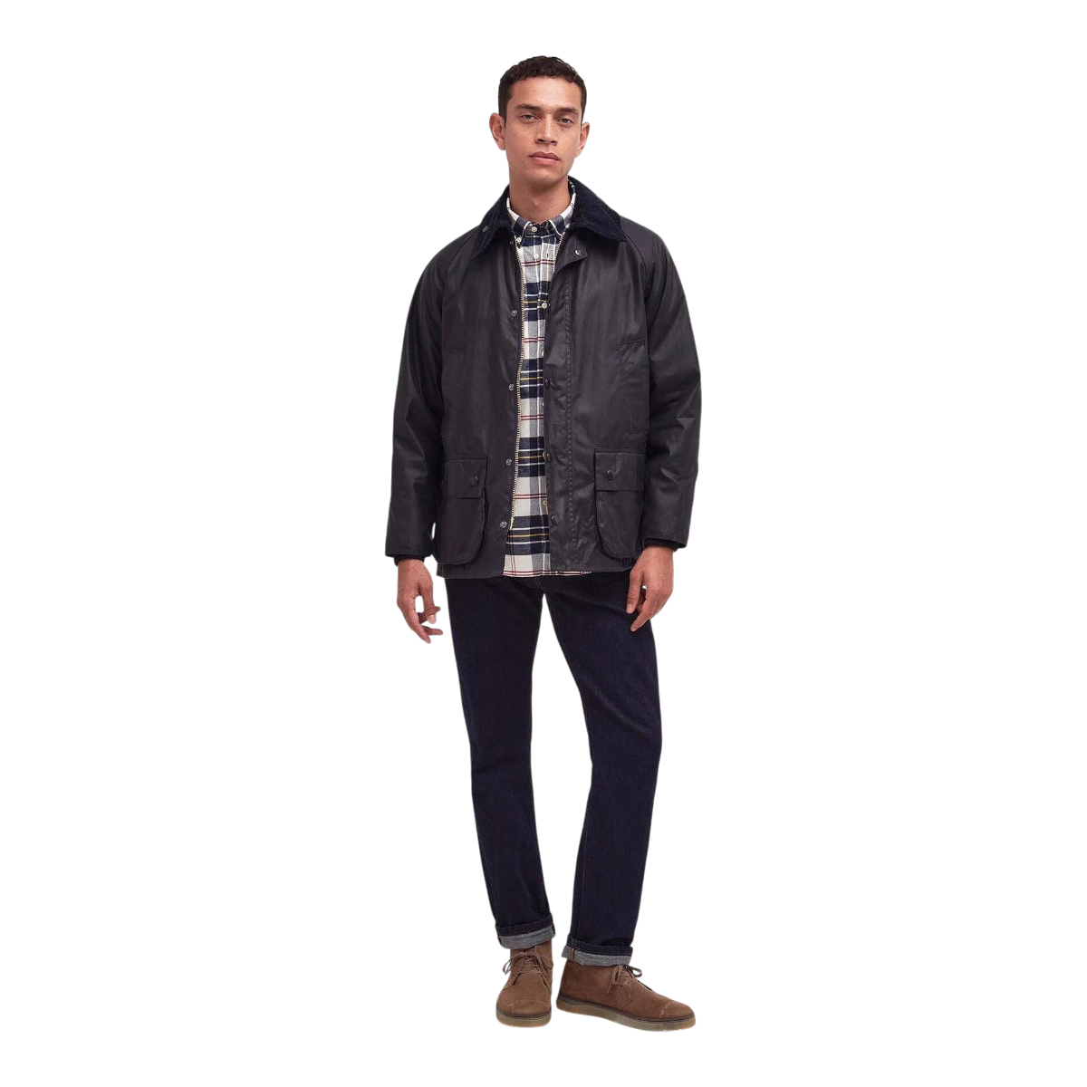 A man wearing a navy MILWORKS Barbour Bedale waxed cotton jacket with a corduroy collar over a plaid shirt and jeans.