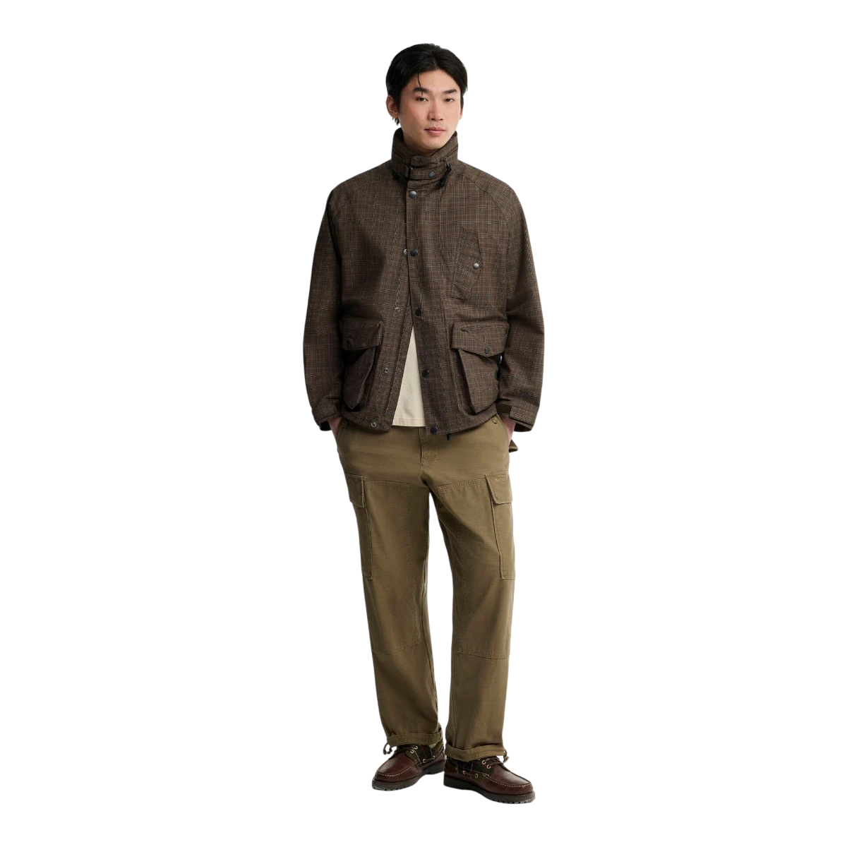 MILWORKS model wearing a Barbour Transport Ursula waterproof jacket in dark stone check with bellow pockets.