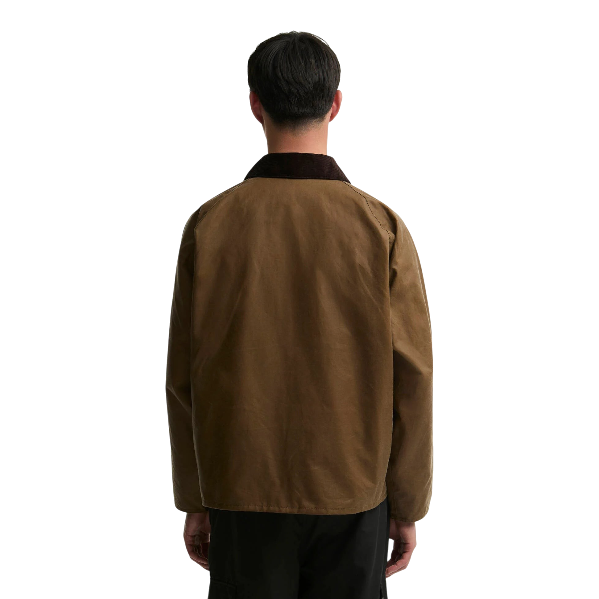 Back view of a man wearing a MILWORKS Barbour Transport sand-coloured waxed cotton jacket with a brown corduroy collar.