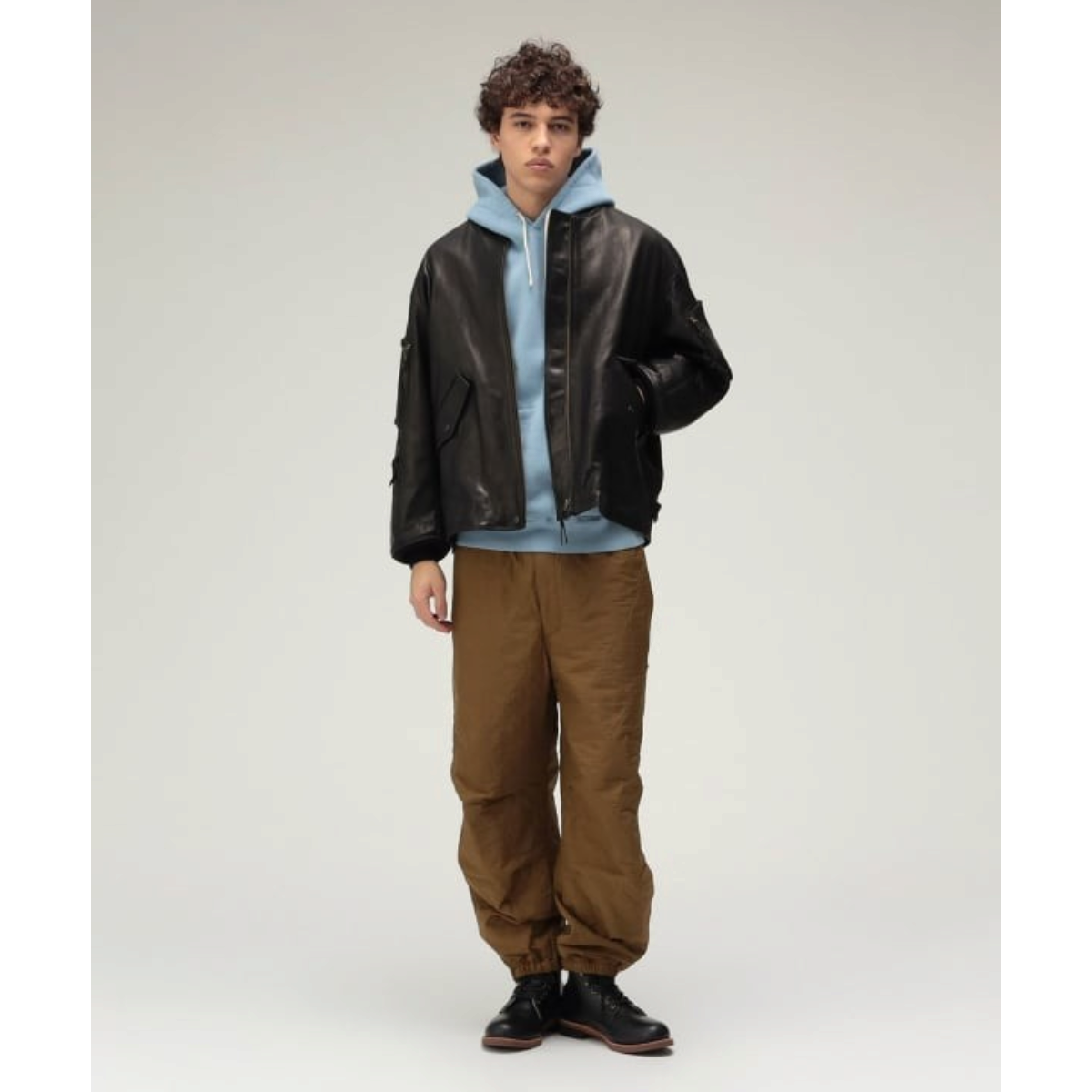 MILWORKS Beams Plus black vegetable tanned leather flight jacket with utility pockets worn by a model