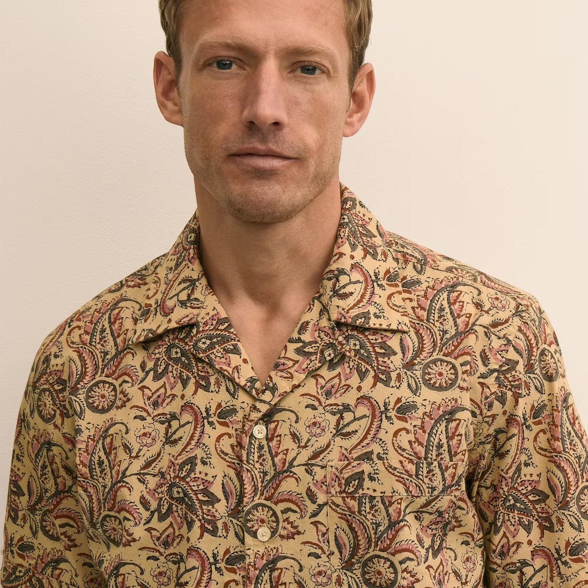 MILWORKS men's beige cotton camp collar shirt with paisley block print, short sleeves, and button-up front.