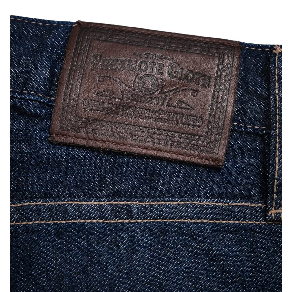 MILWORKS Belford straight fit jeans featuring a dark brown SB Tanning Co leather patch on rinsed Memphis blue denim.