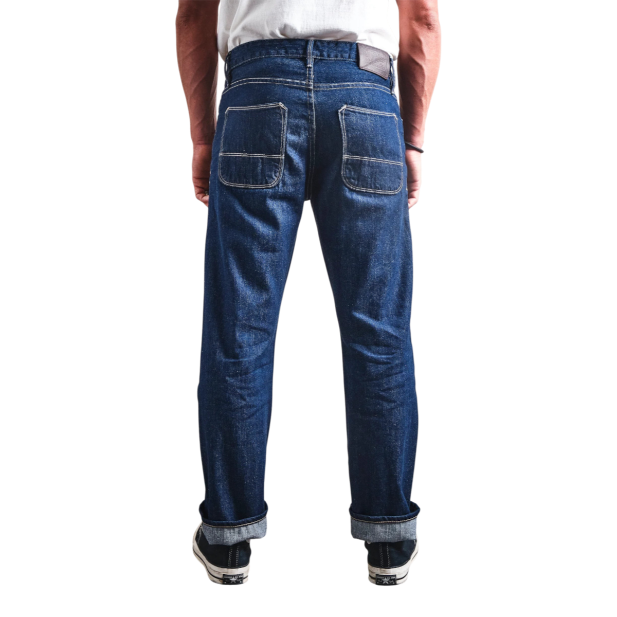 MILWORKS Belford straight fit rinsed blue selvedge denim jeans with leather patch, back view on a model