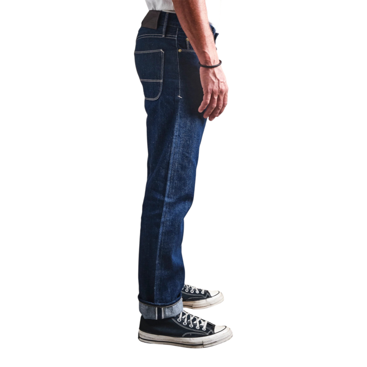 Side view of MILWORKS Belford straight fit rinsed Memphis blue selvedge denim jeans with a leather back patch.