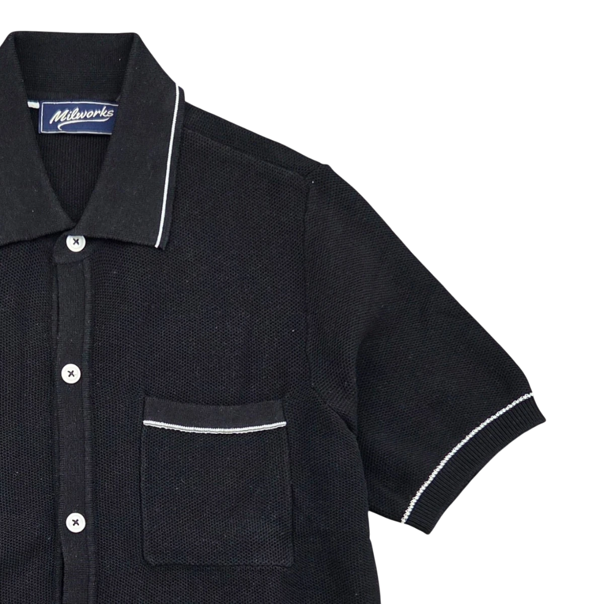 MILWORKS black short sleeve cotton knit polo shirt with white piping detail and chest pocket.
