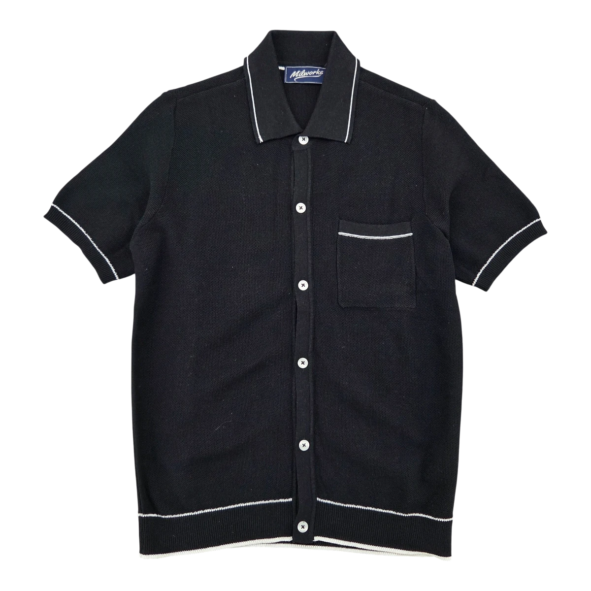 MILWORKS black short sleeve cotton knit shirt with white piping on collar, cuffs, and hem. Features a chest pocket and button front.