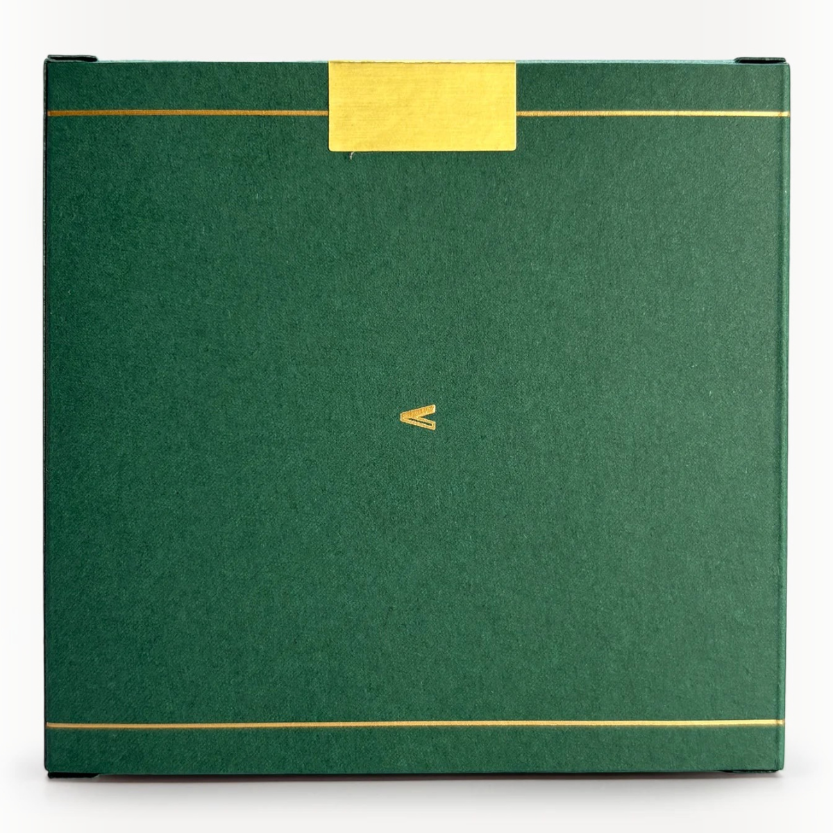MILWORKS Black Hemlock perfume box in dark green with gold foil accents and a minimalist V logo