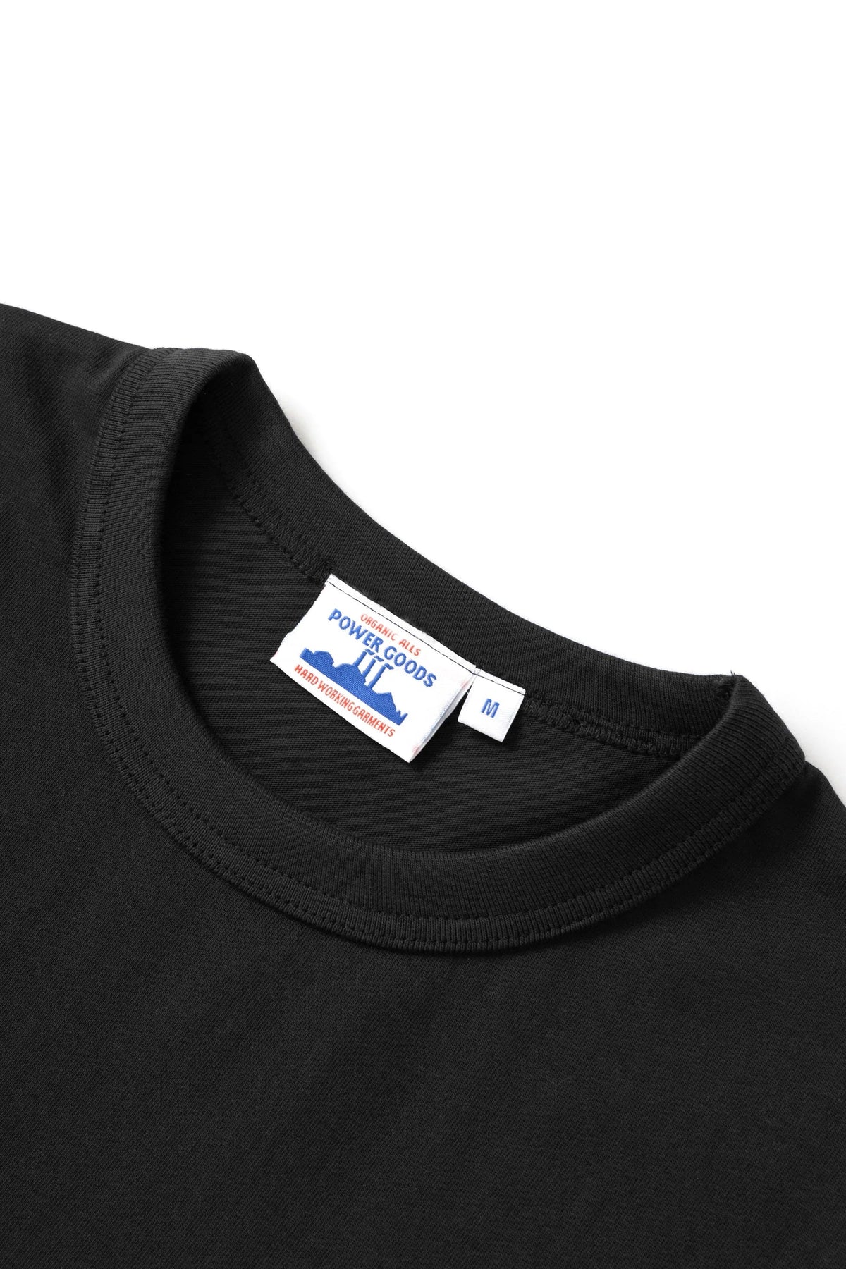 MILWORKS 7.5oz Archive Tee in black organic cotton with a vintage-inspired ribbed neckline and branded inner label.