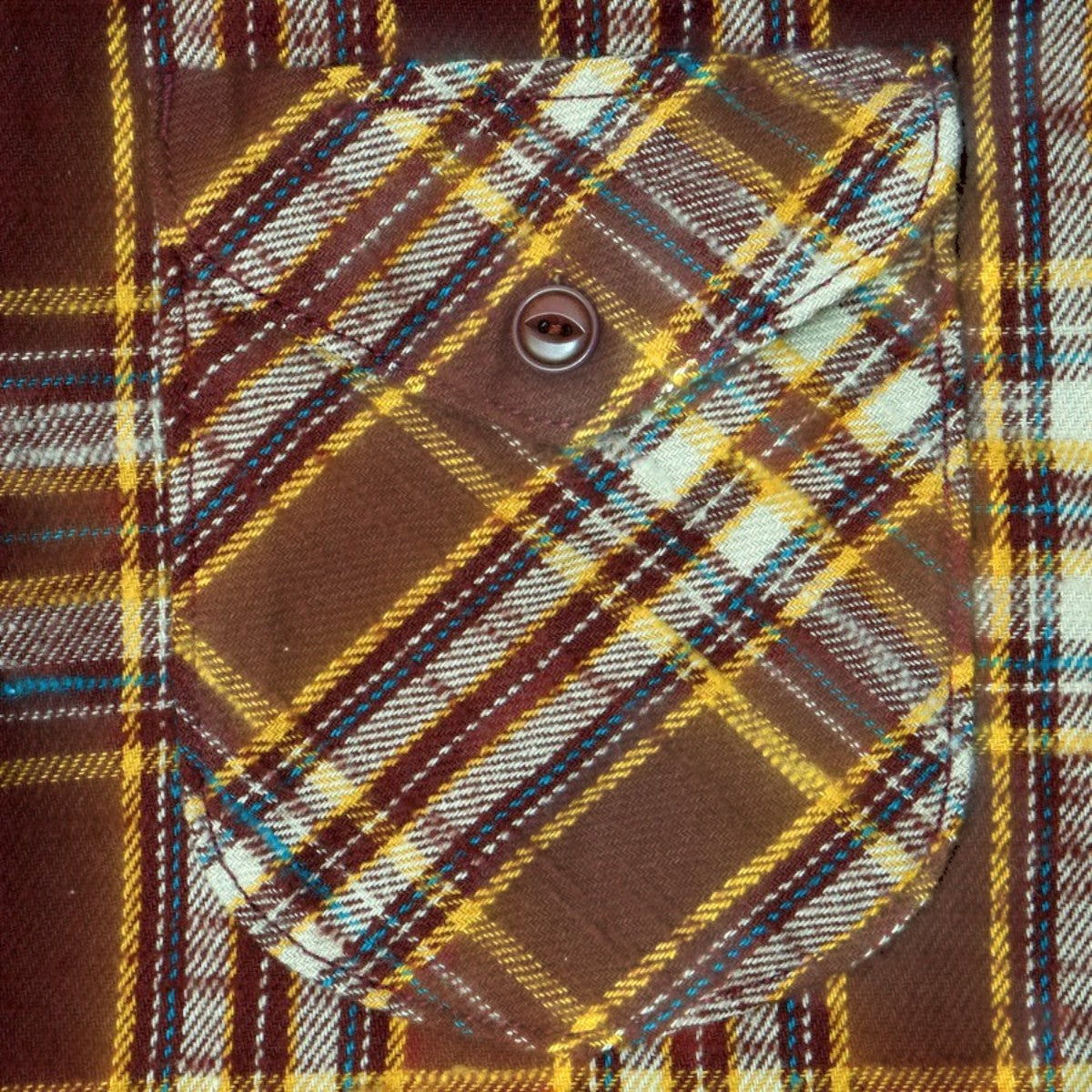 MILWORKS brown slub flannel shirt featuring a textured check pattern and a single buttoned chest pocket.