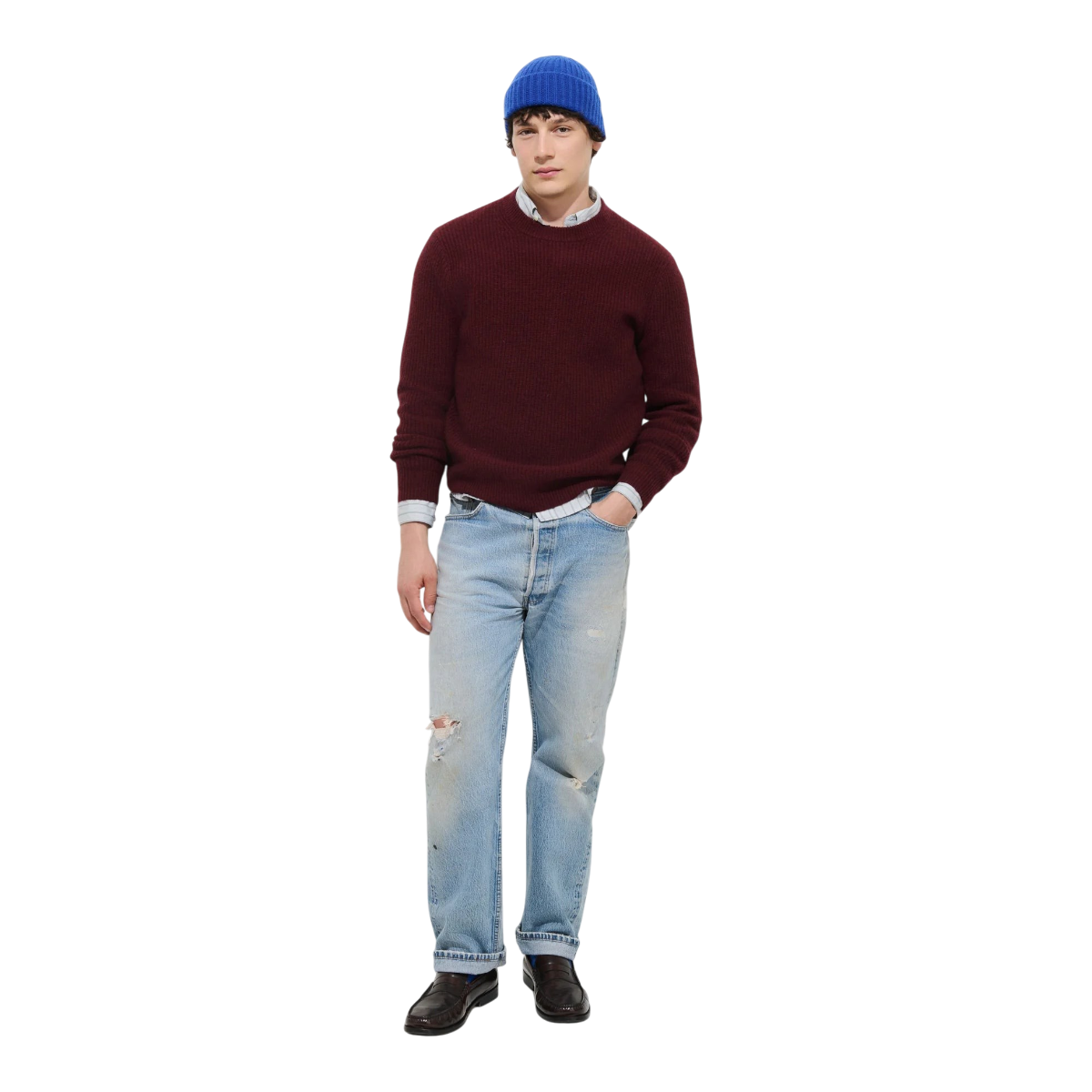 MILWORKS model wearing a heather burgundy 100% cashmere crewneck sweater with a bright blue beanie and distressed jeans