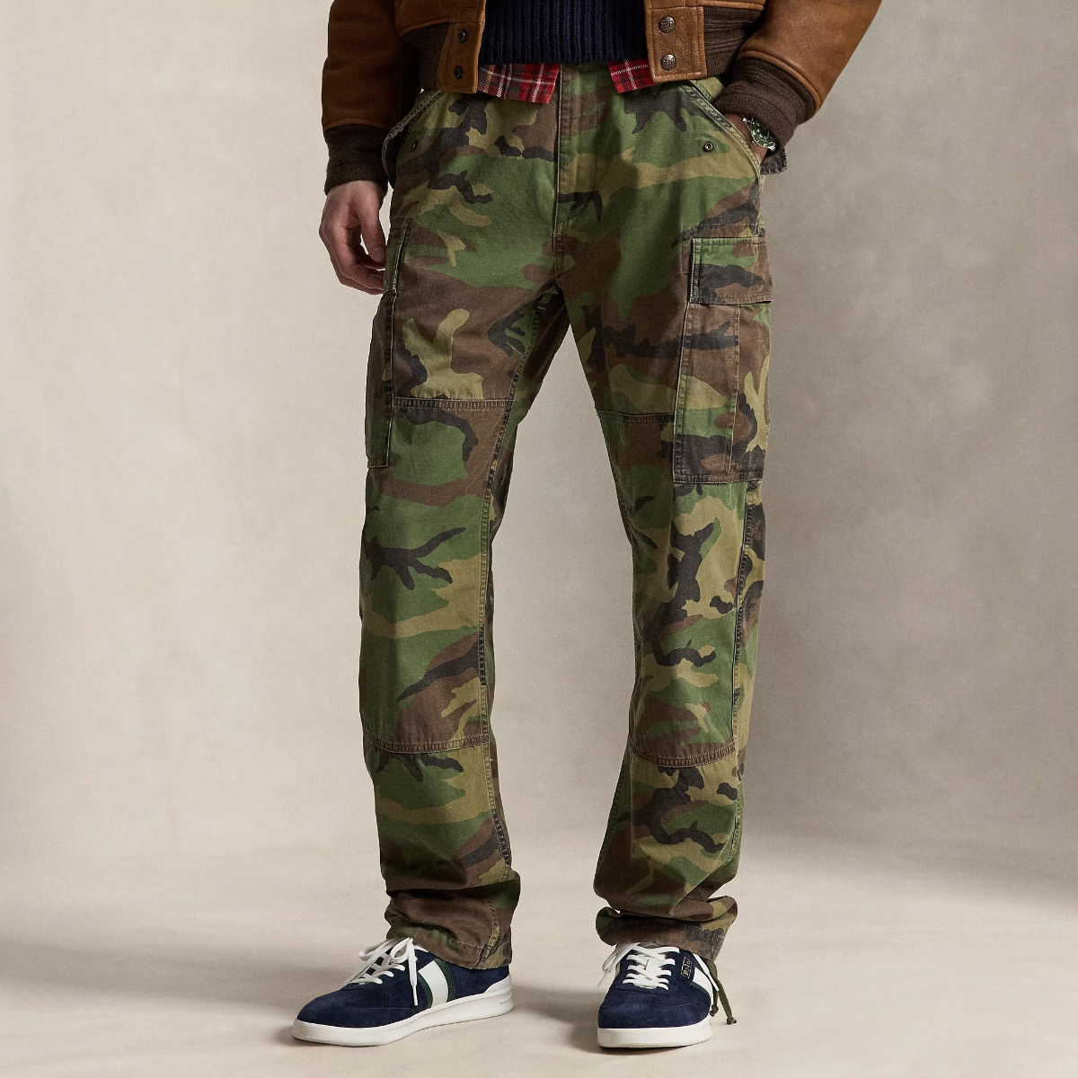 A model wearing MILWORKS classic fit camo cargo pants in cotton canvas with side pockets and drawstring hems.
