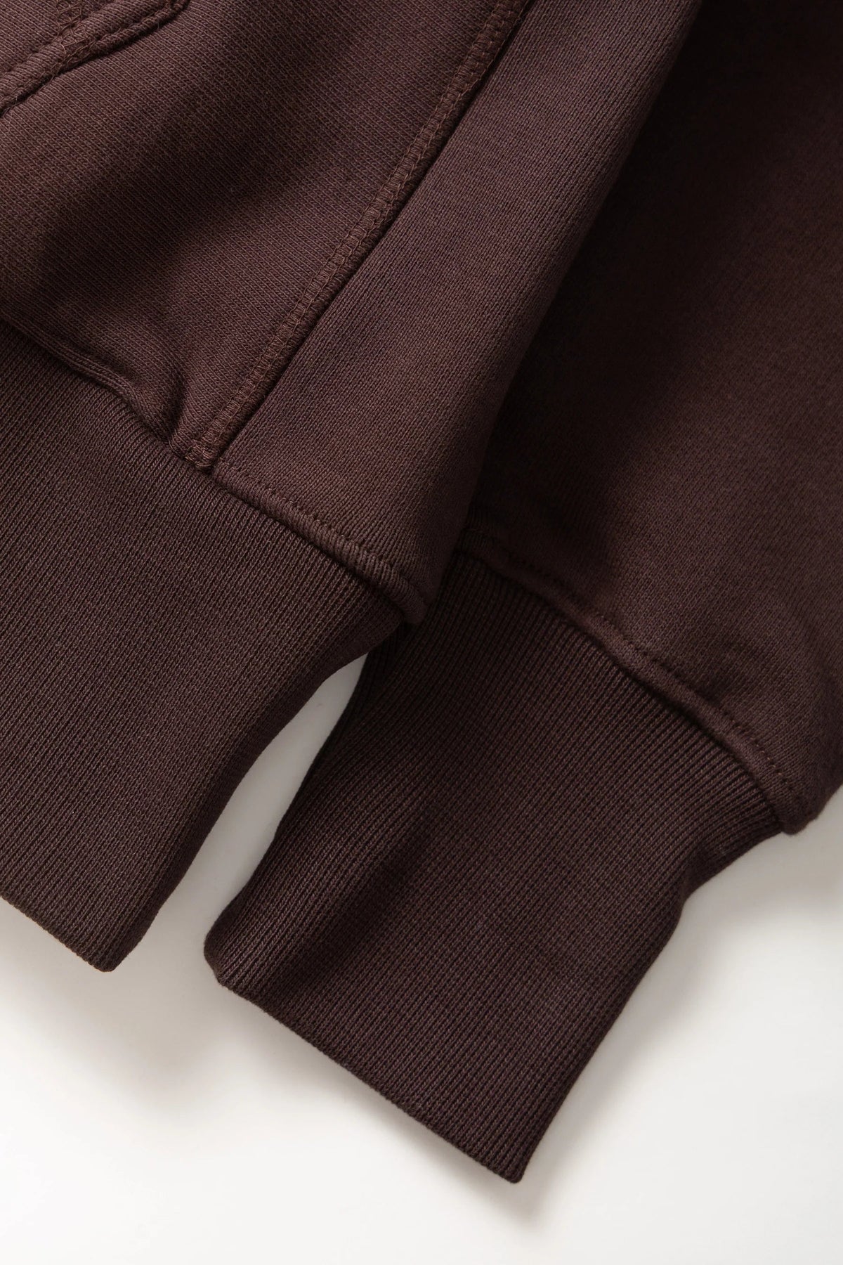 MILWORKS coffee brown 16oz organic cotton brushed fleece hoodie showing ribbed cuffs and side panel detail.